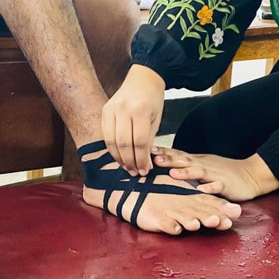 Kinesio taping applied to the ankle and lower limb to support movement and functional mobility